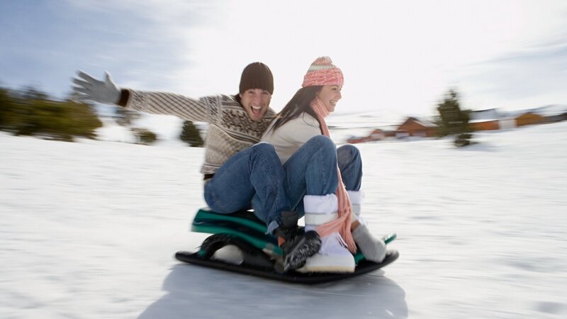 Couple Sledding
