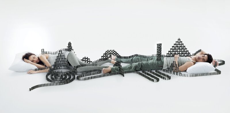 Couple sleeping with domino art