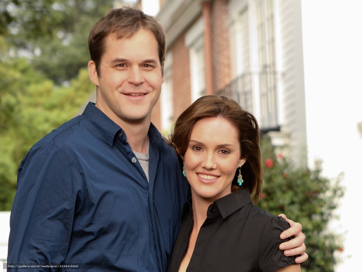couple standing outside house