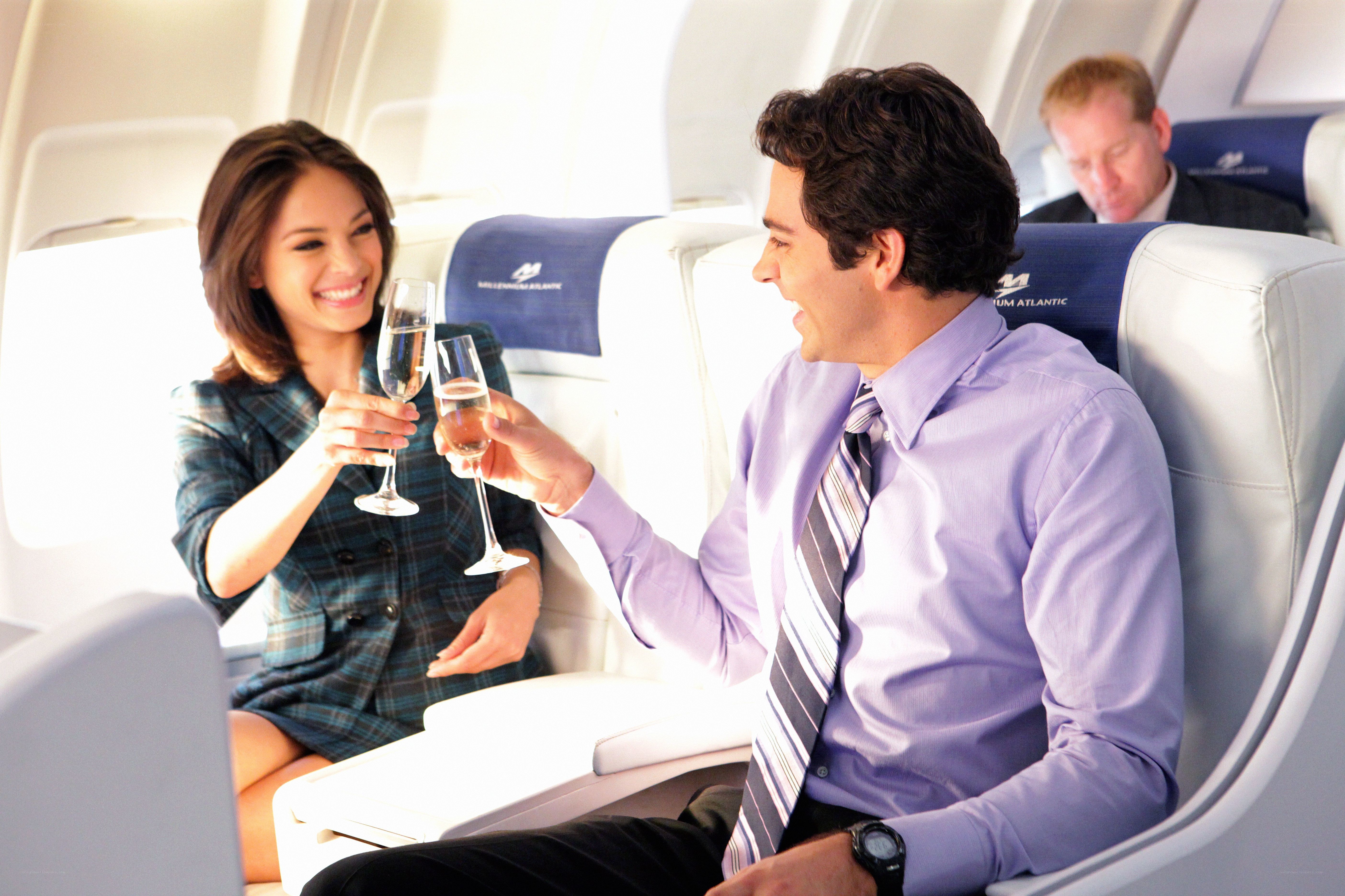 Couple toasting on airplane