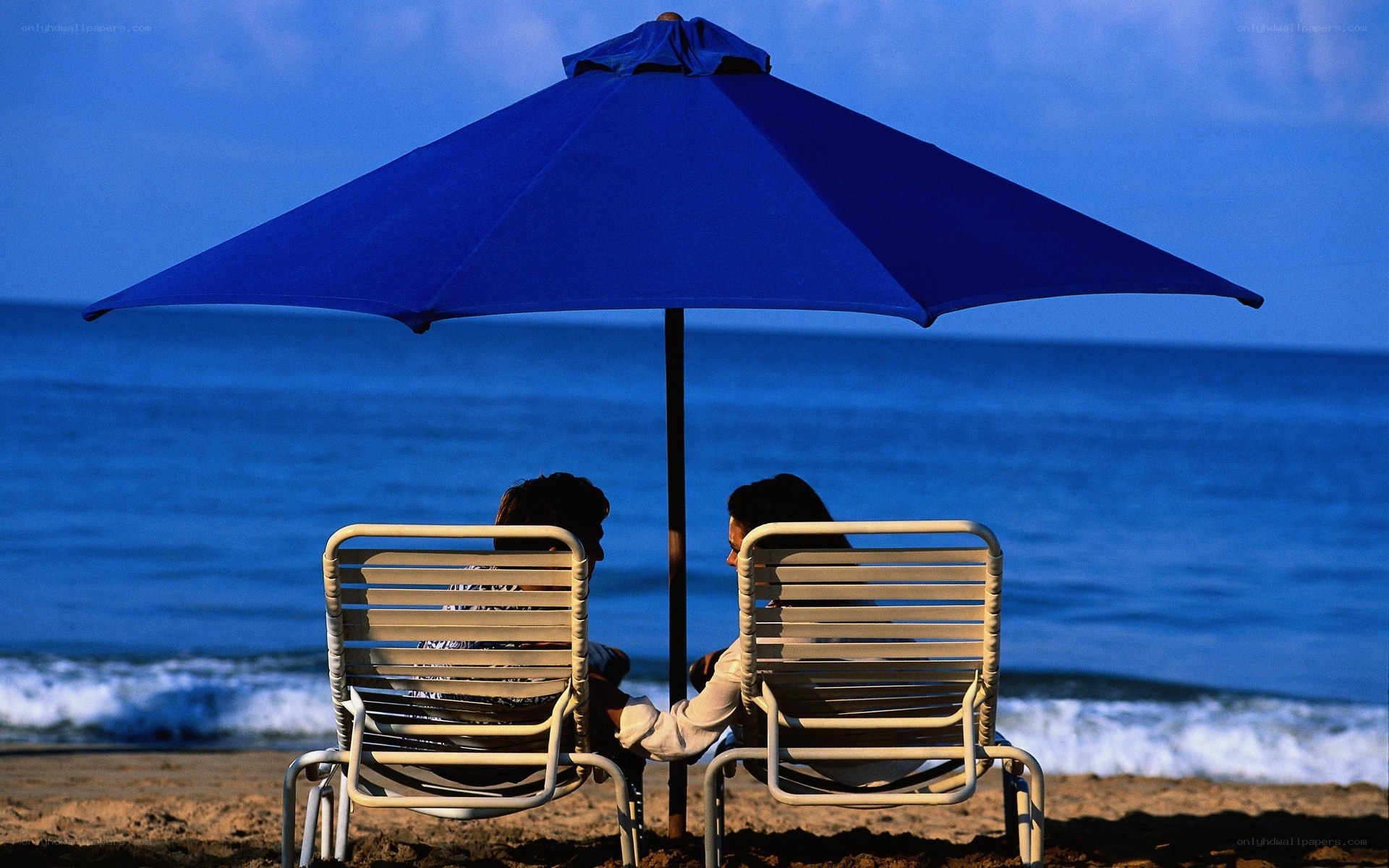 Couple under beach umbrella