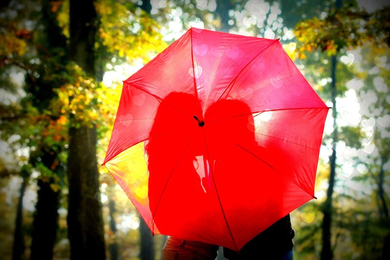 Couple under red umbrella