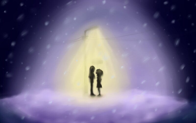 Couple under streetlight in snow