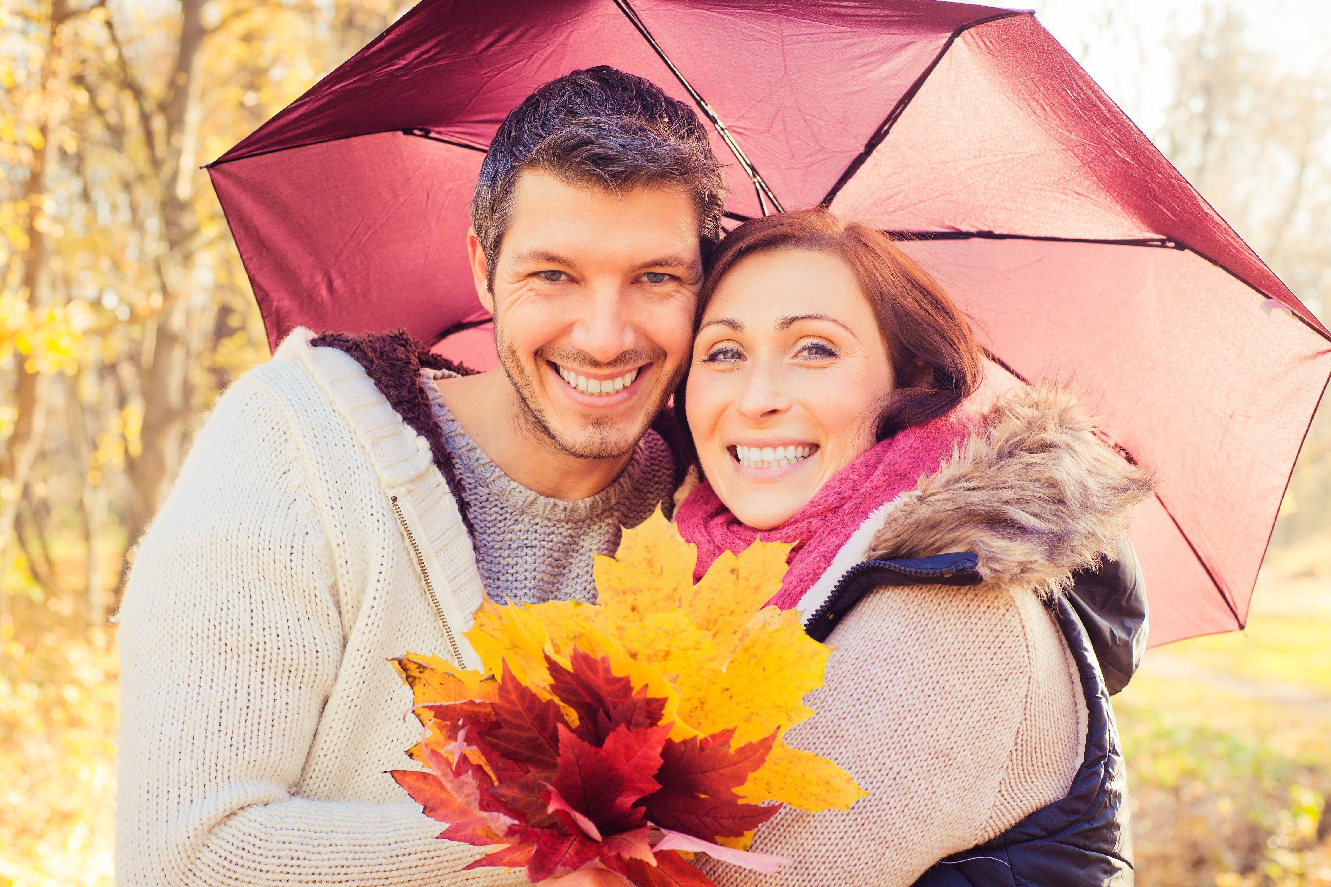 Couple under umbrella in autumn