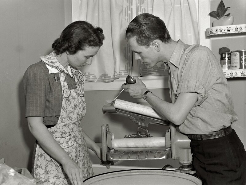 Couple using a wringer washer
