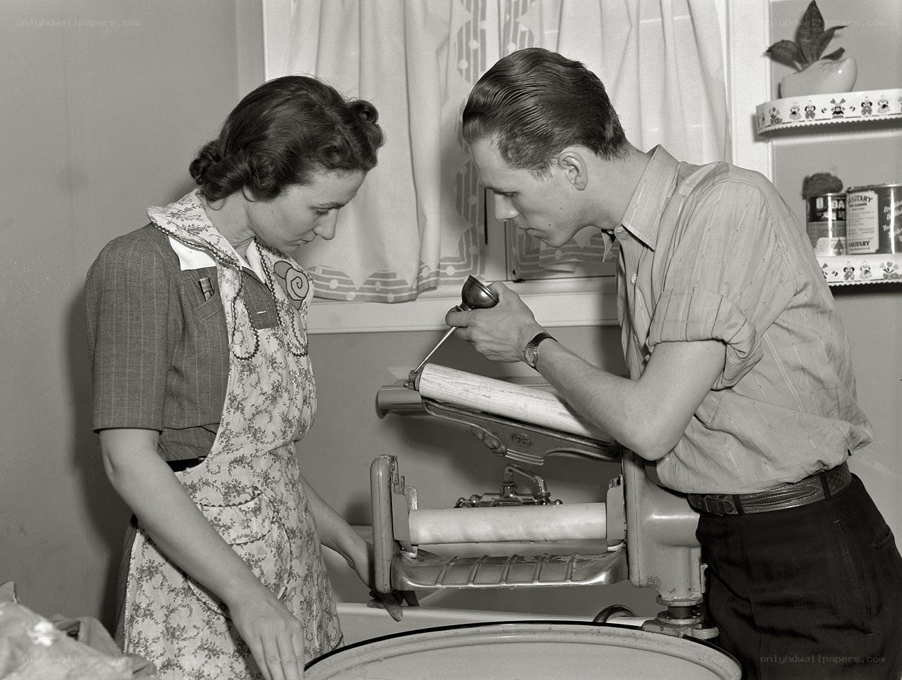 Couple using a wringer washer