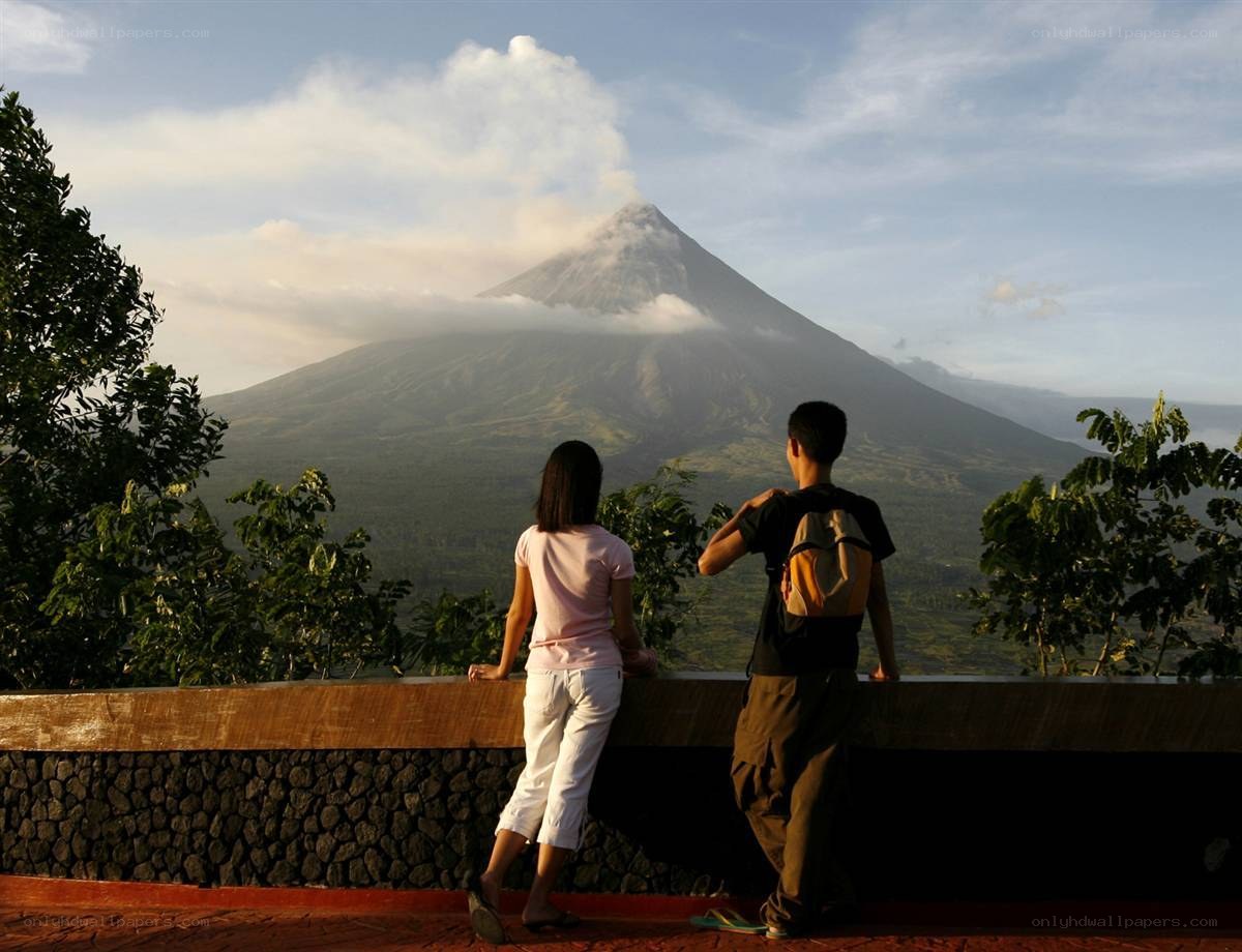 Couple views smoking volcano