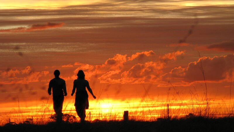 Couple Walking at Sunset — Orange, Dramatic