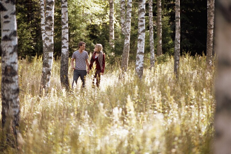 Couple walking in birch forest