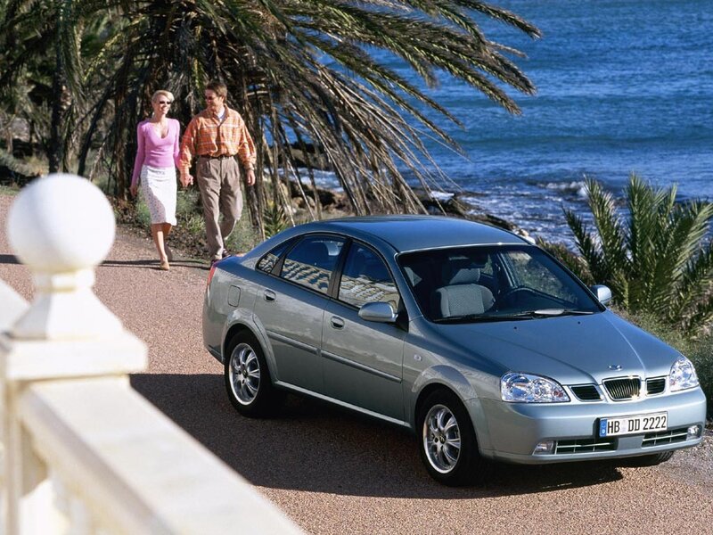 Couple walking near car by the sea