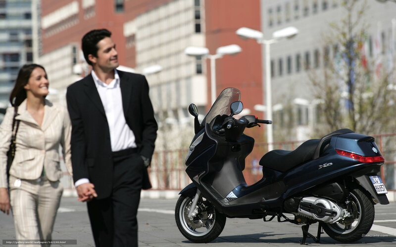 Couple walking near scooter