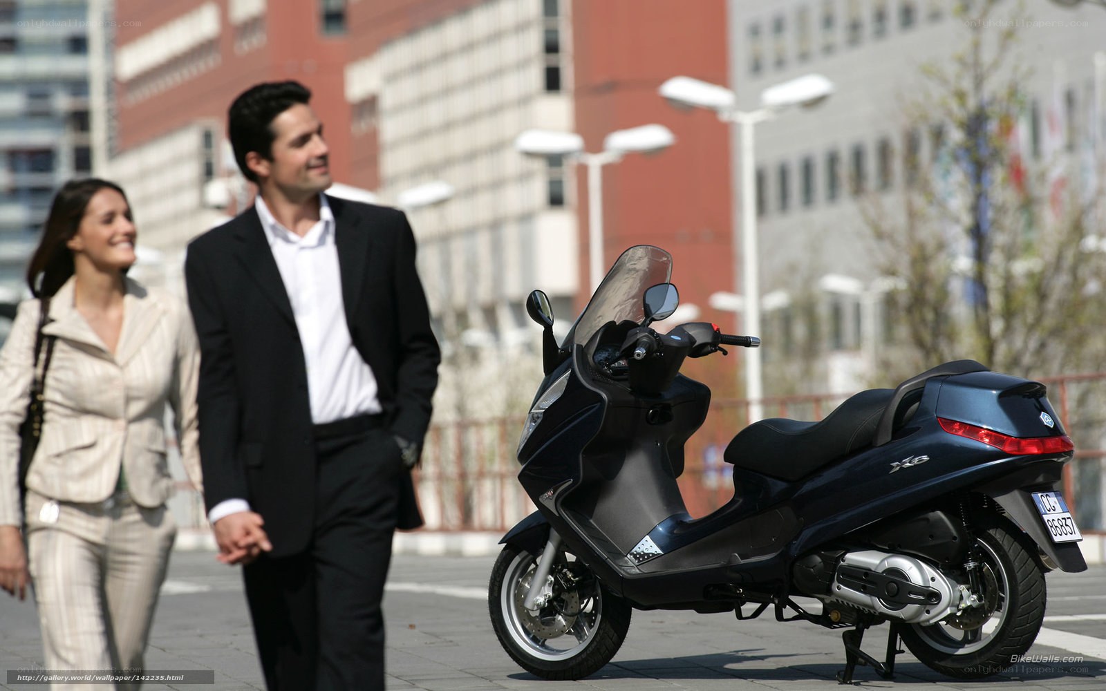 Couple walking near scooter