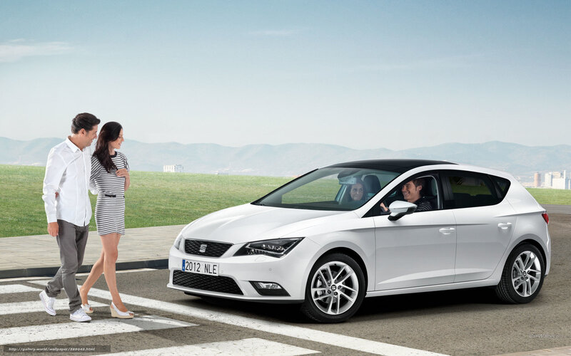 Couple walking near white car