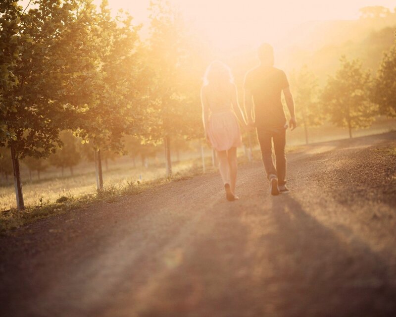 Couple walking on a path at sunset