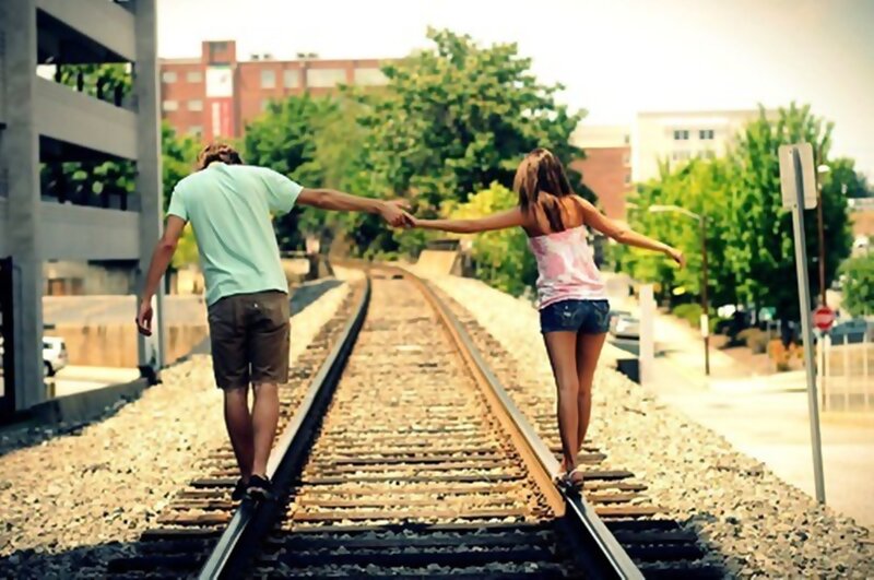Couple Walking on Train Tracks