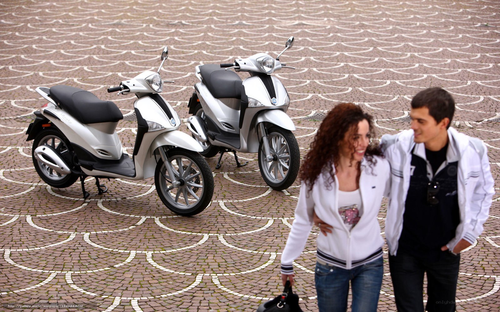 Couple walking past scooters