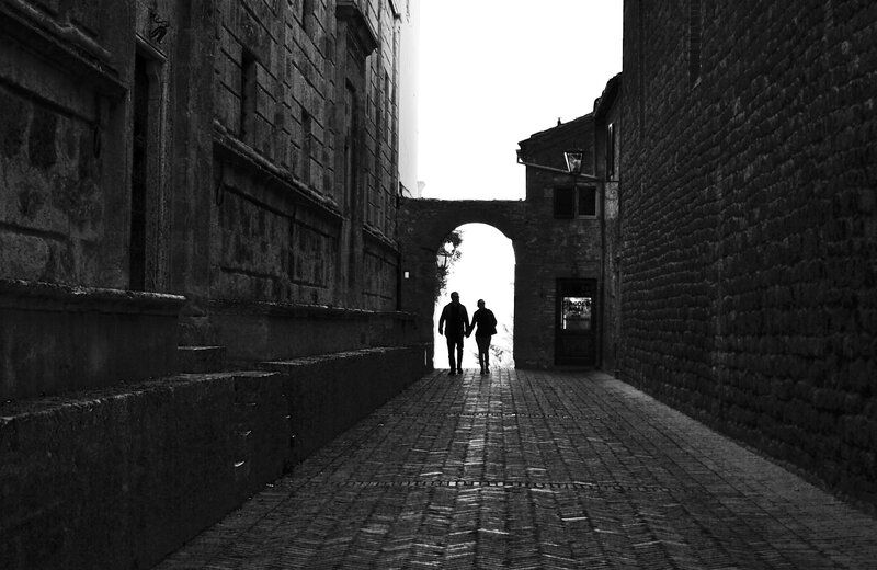 Couple walking through a narrow alley