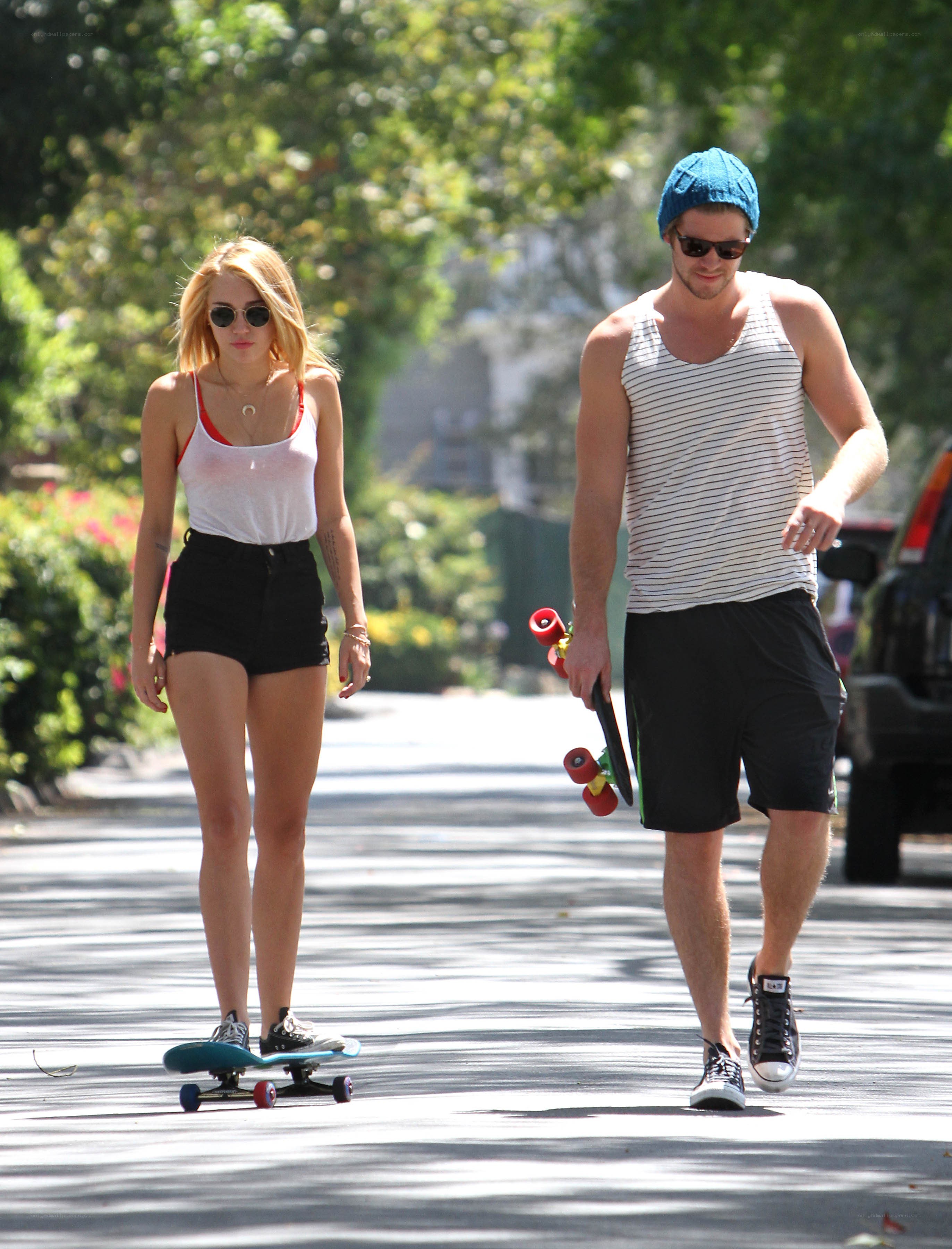 Couple walking with skateboards