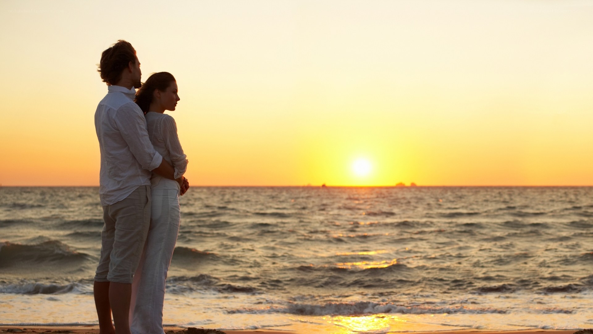Couple watching sunset at beach
