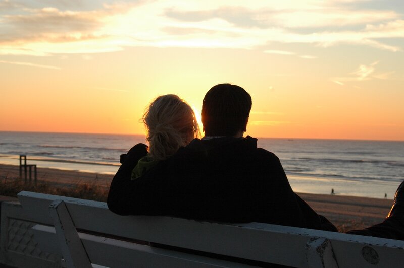 Couple watching sunset at beach