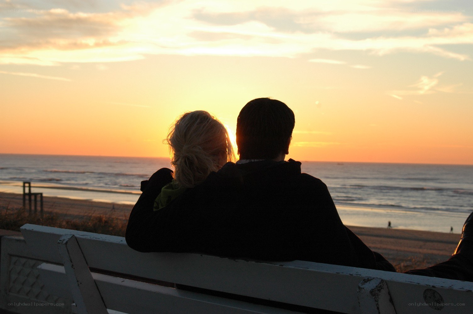Couple watching sunset at beach