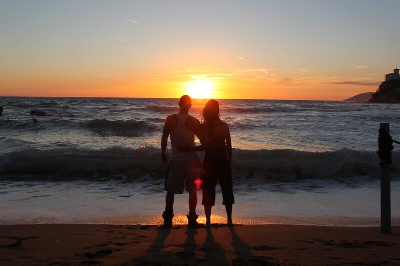 Couple watching sunset at beach