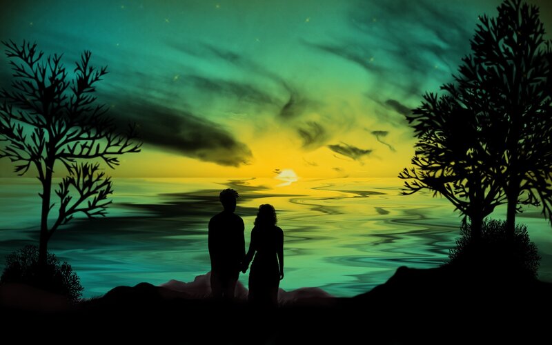 Couple watching sunset by the sea