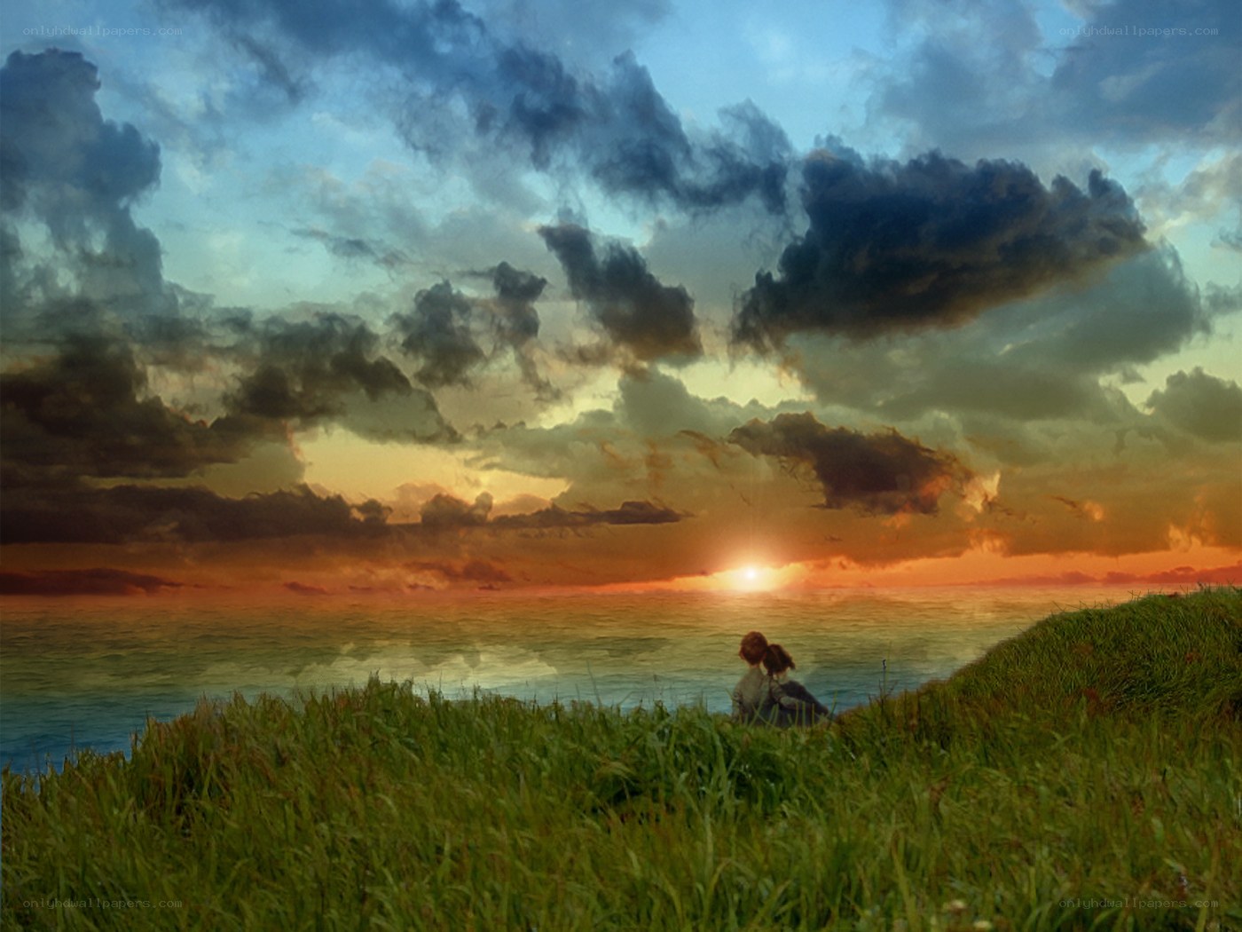 Couple watching sunset on a cliff