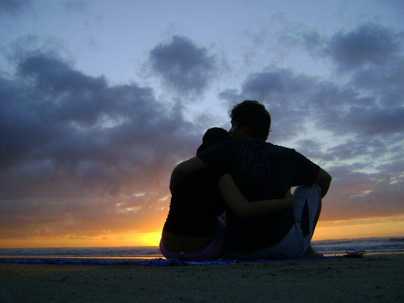 Couple watching sunset on beach