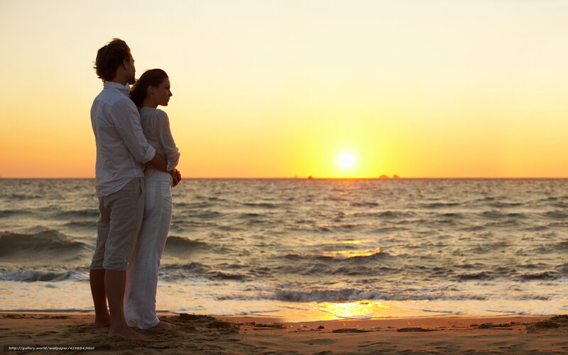 Couple watching sunset on beach