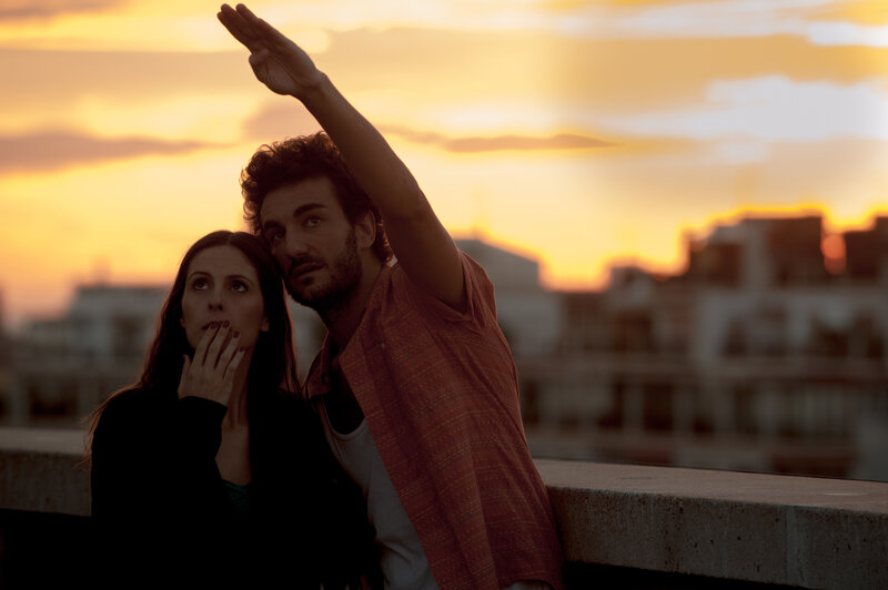 Couple watching sunset on rooftop