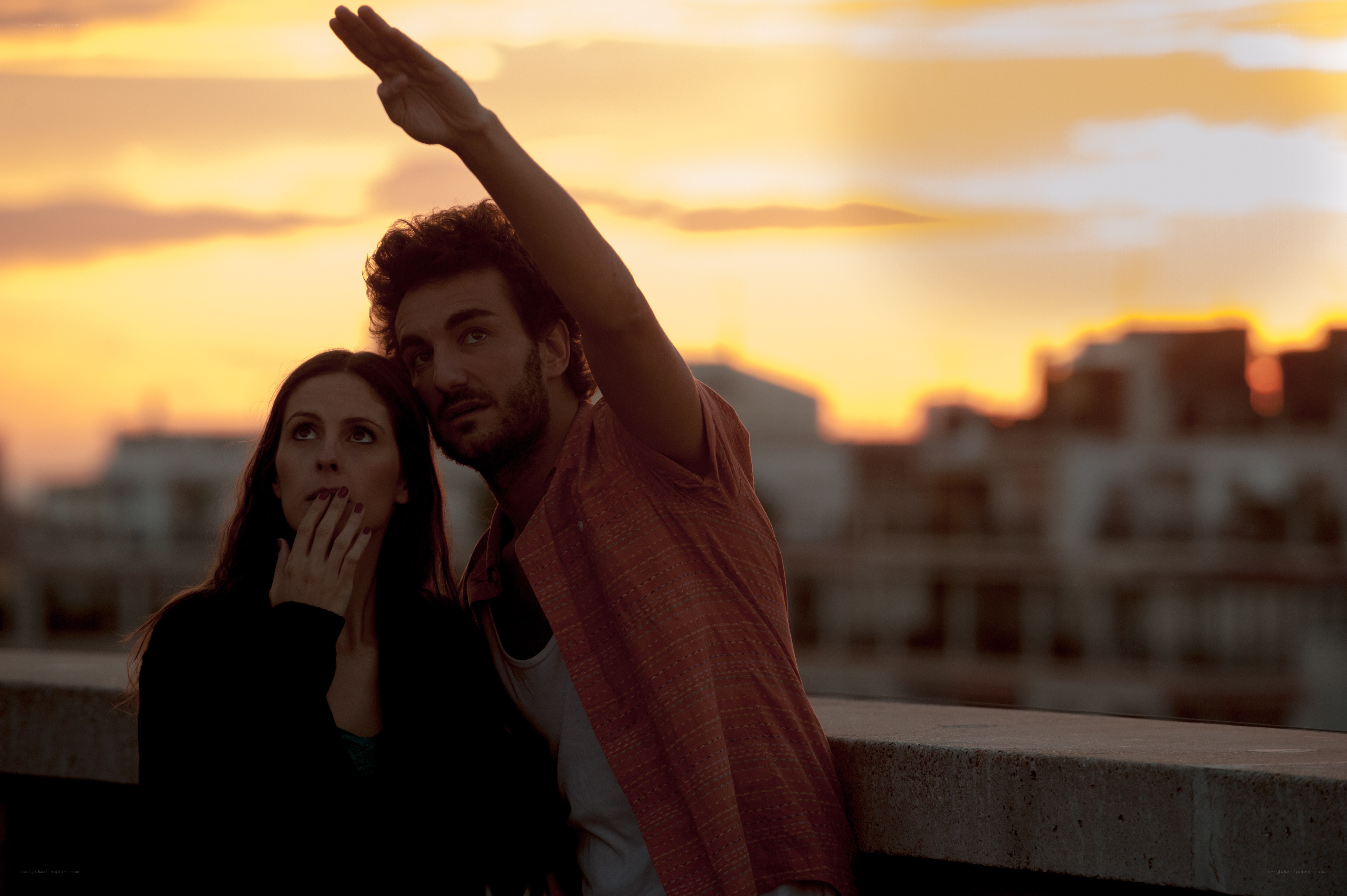 Couple watching sunset on rooftop