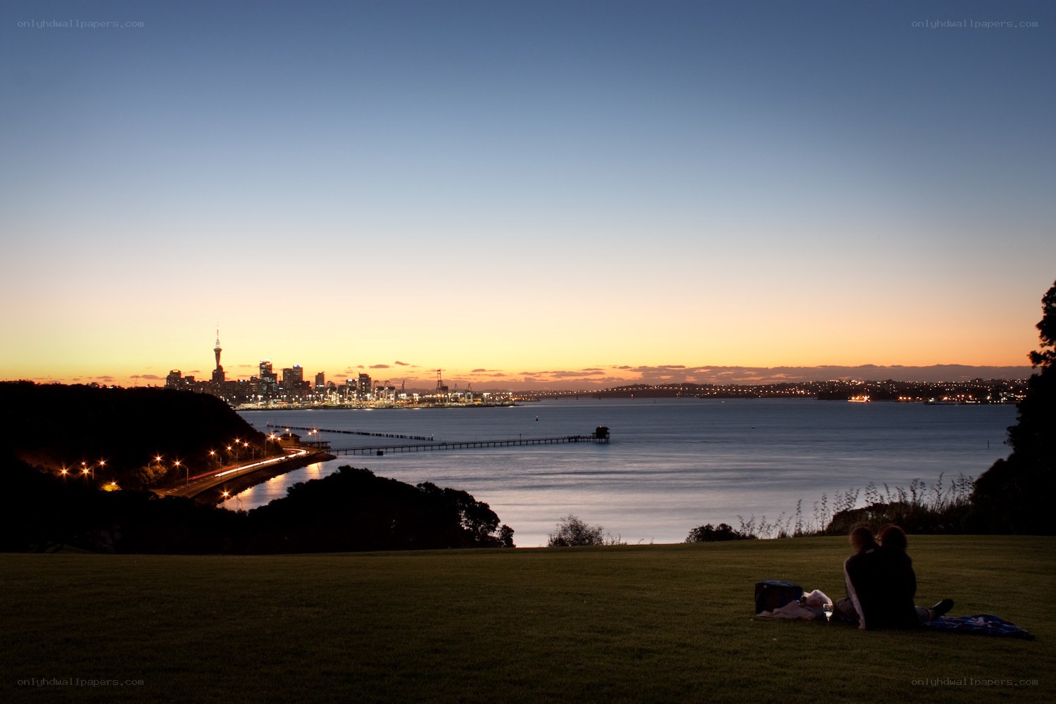 Couple watching sunset over city