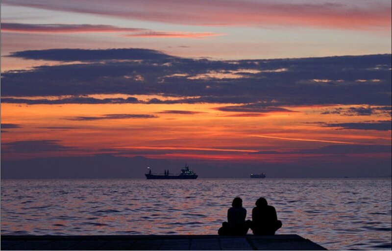 Couple watching sunset over water