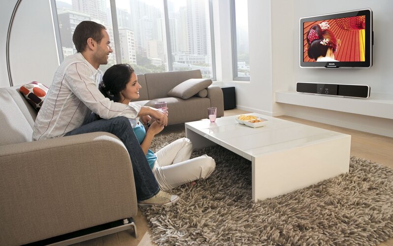 Couple watching TV at home