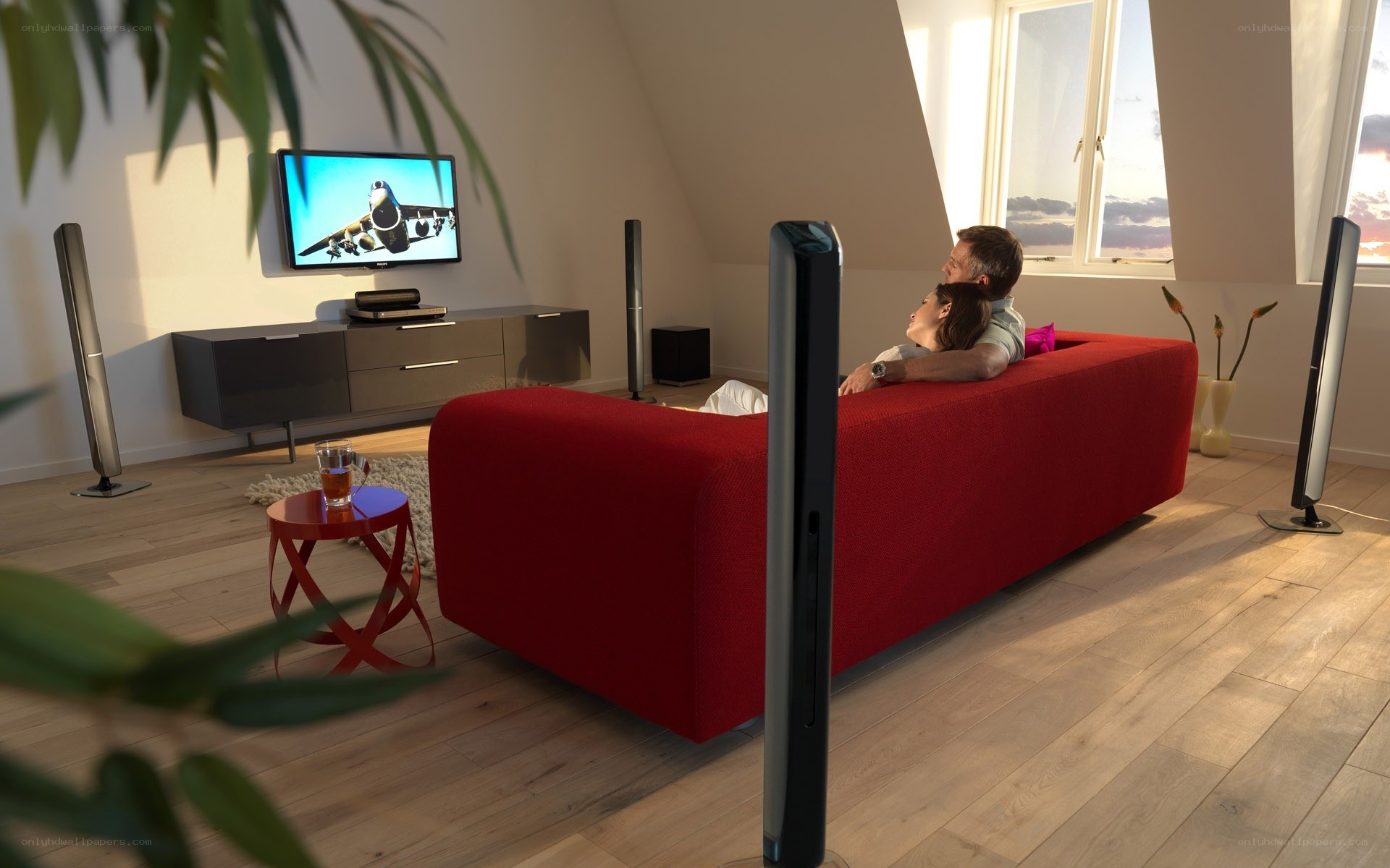 Couple watching TV on red sofa