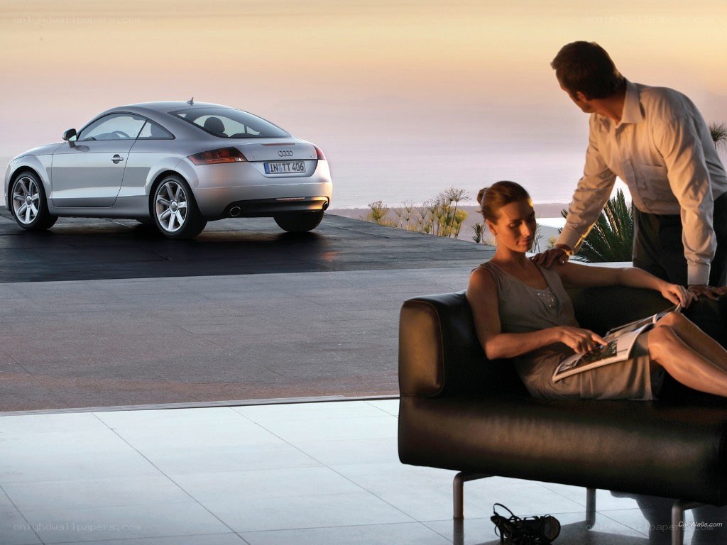 Couple with Audi TT at sunset