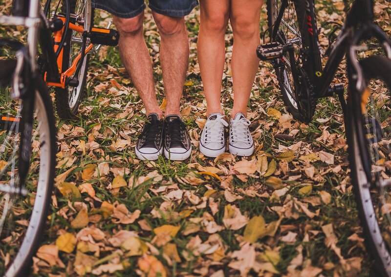 couple with bicycles in autumn