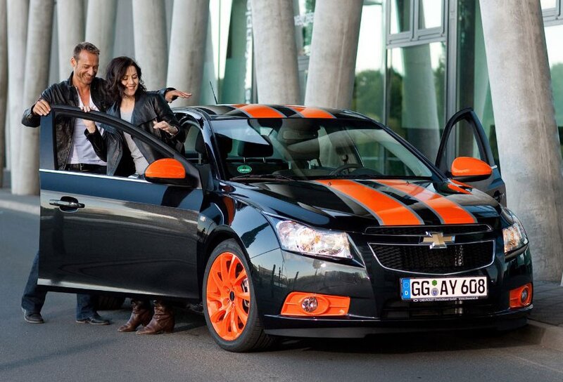 Couple with black and orange car