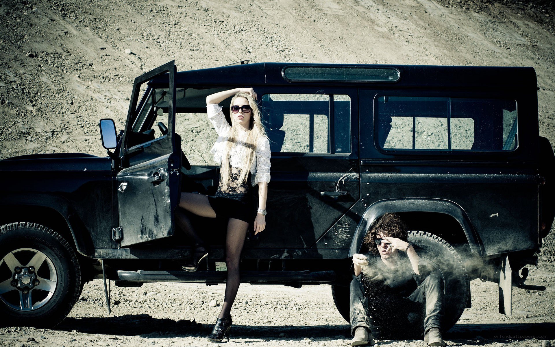 Couple with black SUV in desert