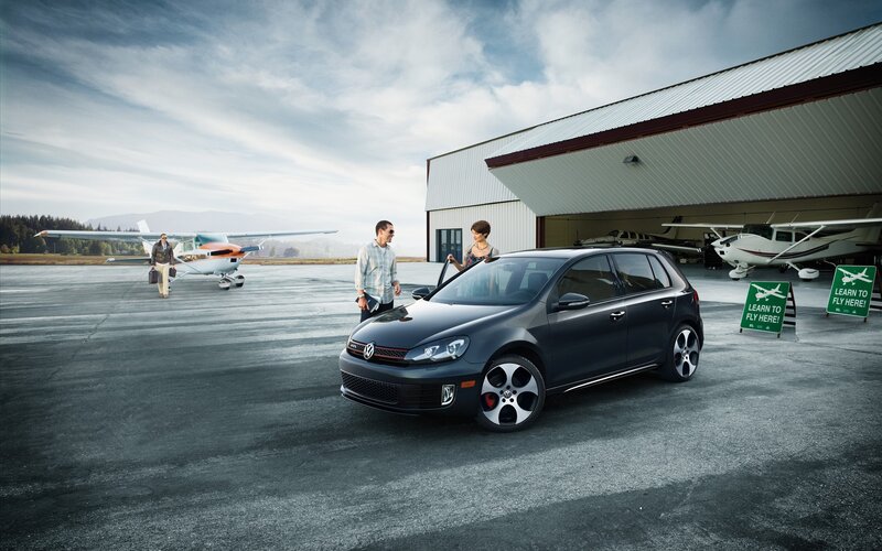 Couple with car at airfield