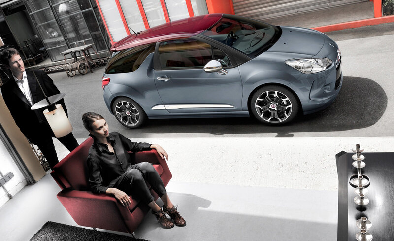 Couple with car in modern setting