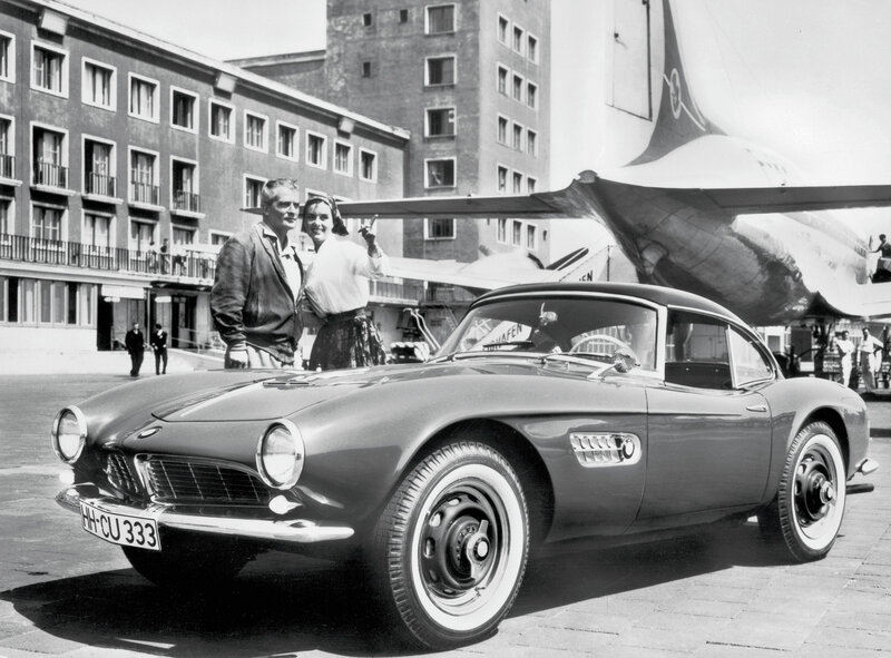 Couple with classic car at airport