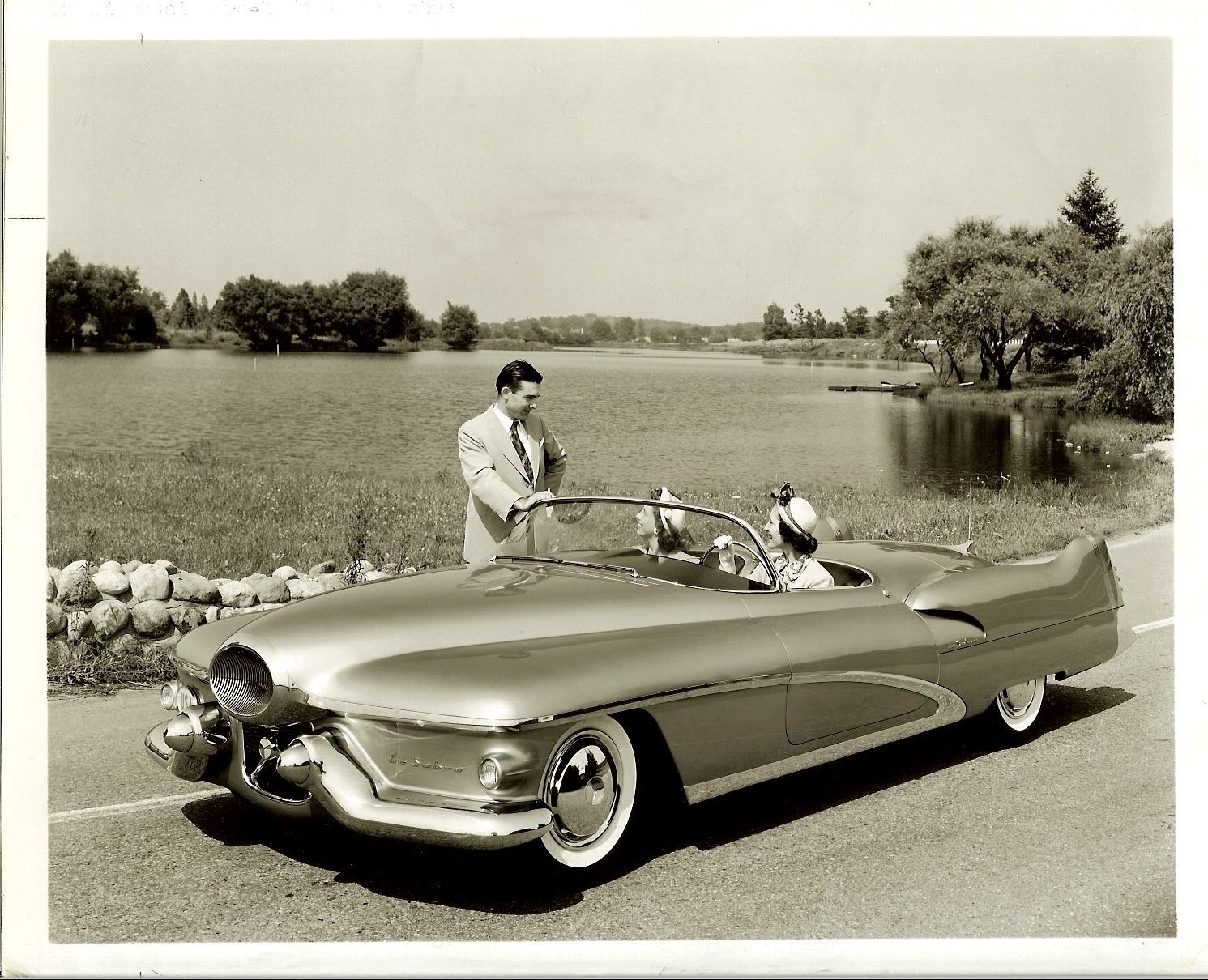 Couple with classic car by lake