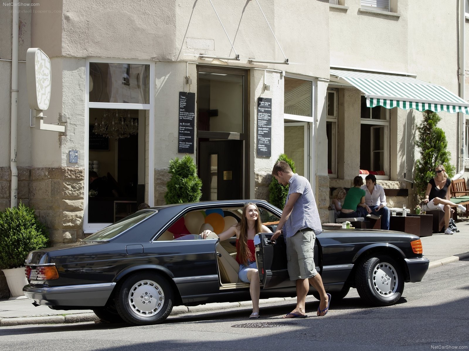 Couple with classic car on street