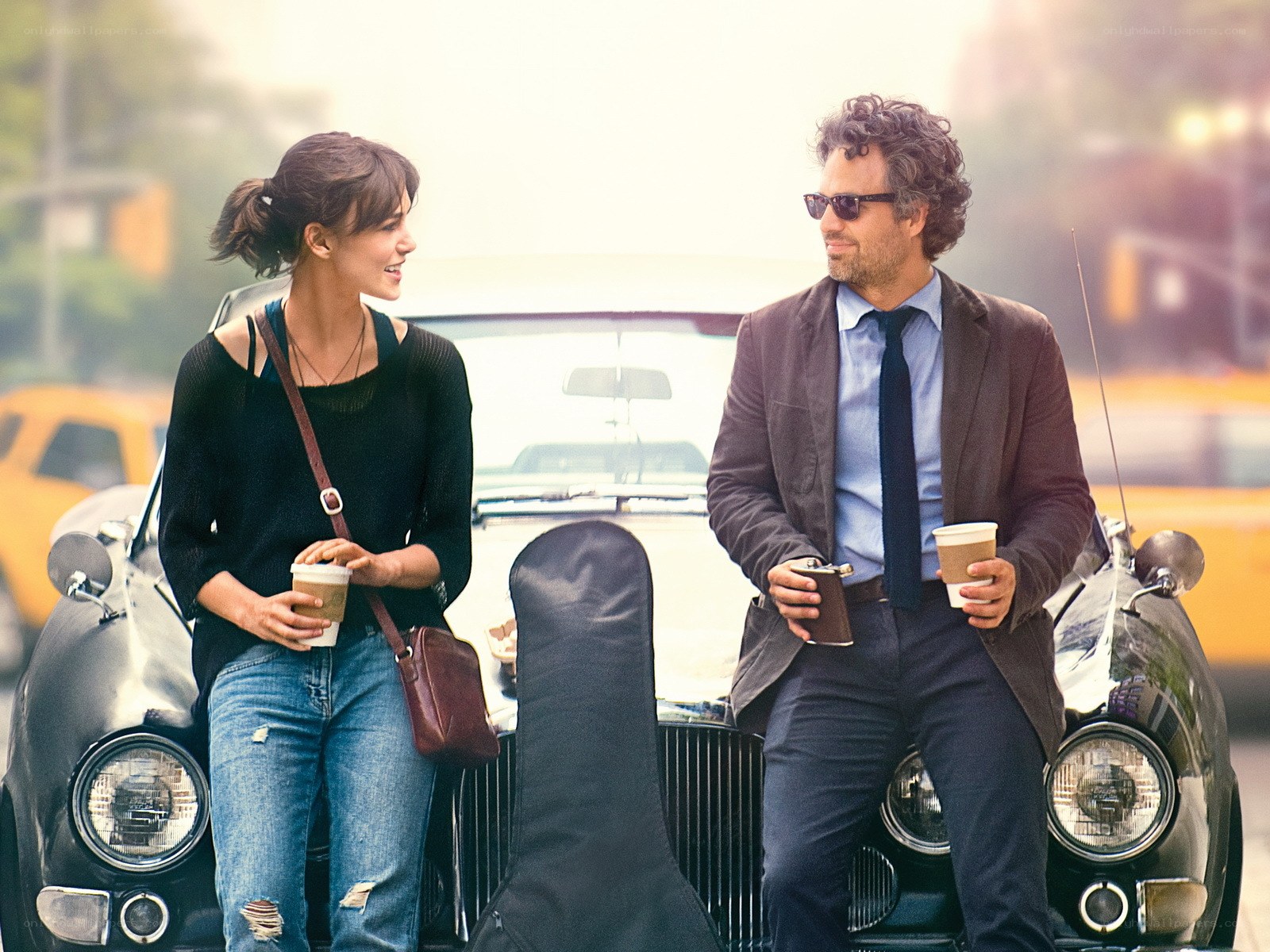 Couple with coffee by classic car