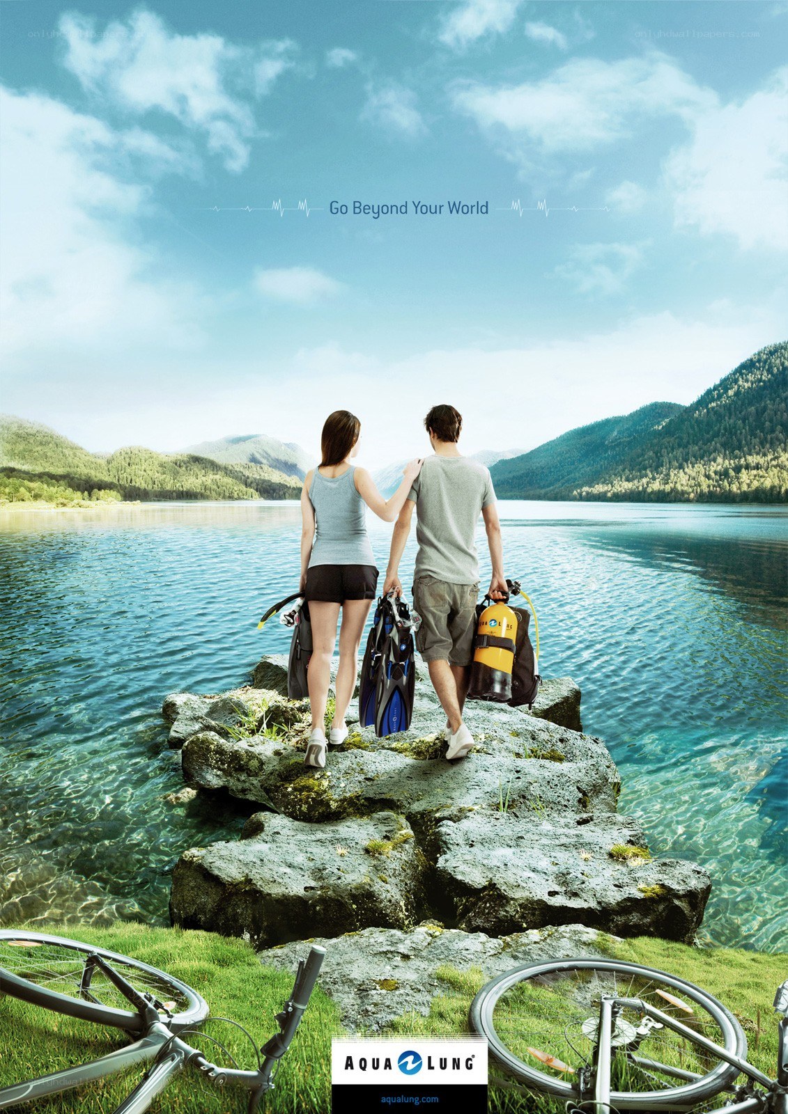 Couple with diving gear by lake