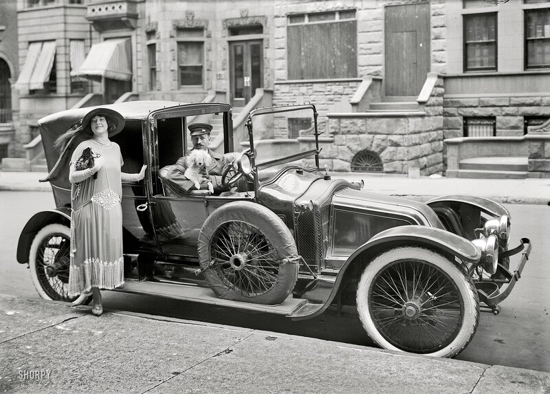 Couple with dog in vintage car