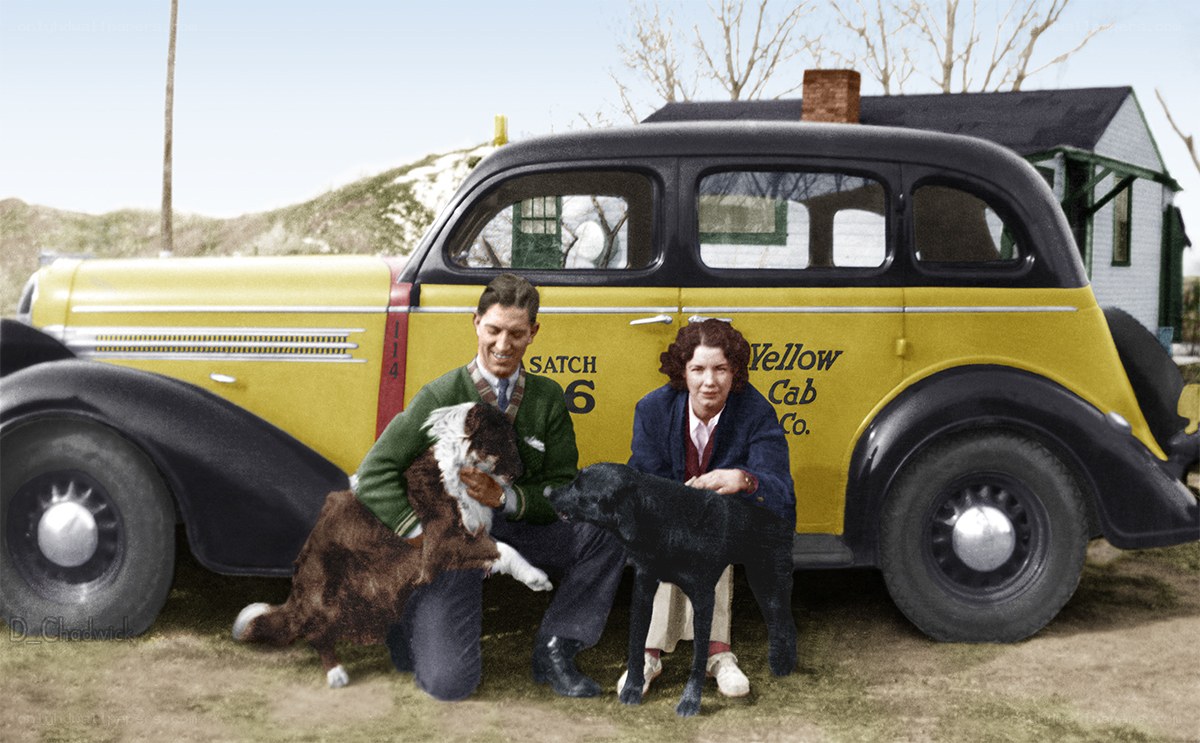 Couple with dogs by vintage cab