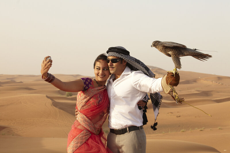 Couple with Falcon in Desert